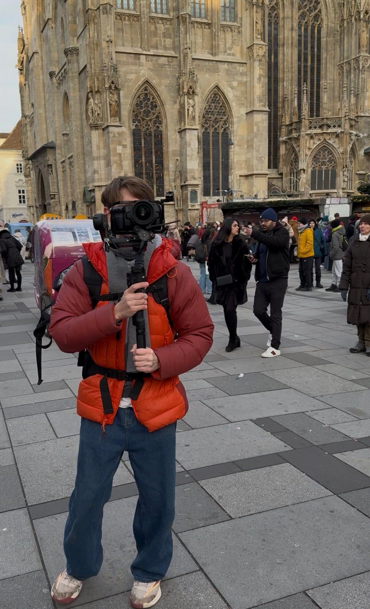 Cameraman filming in front of Vienna cathedral